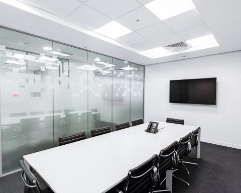 rectangular white table with rolling chairs inside room