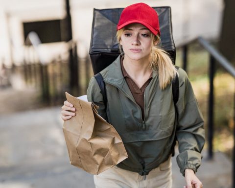 woman with paper bags and backpack