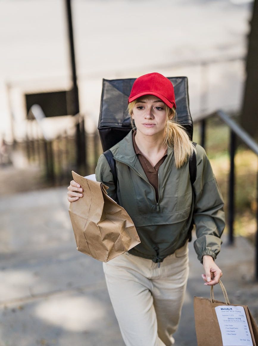woman with paper bags and backpack