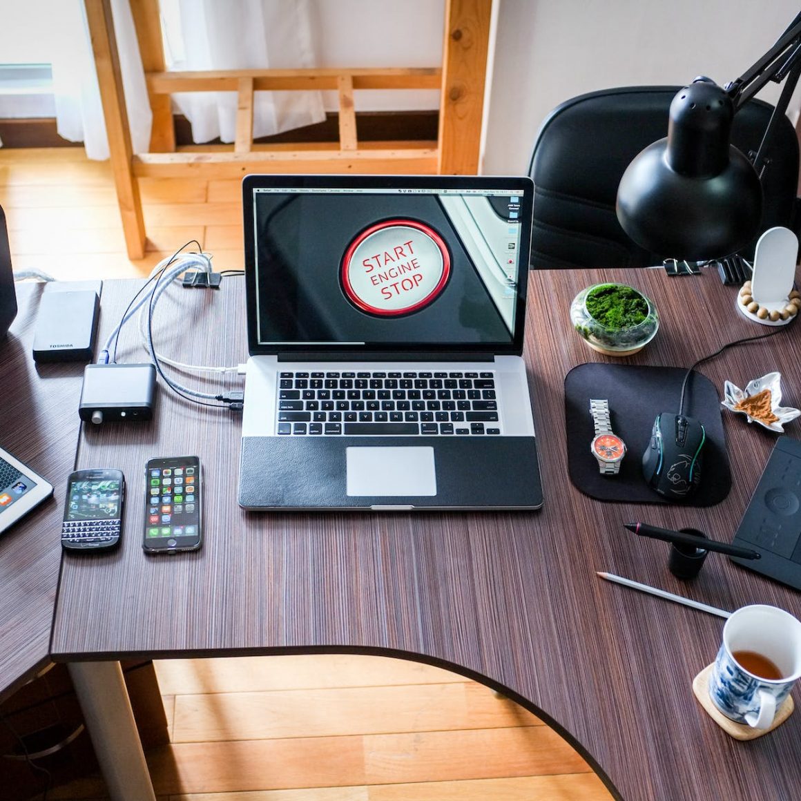 black and white laptop computer on brown wooden desk