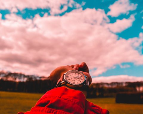 person in red shirt wearing watch