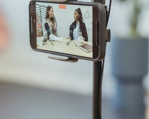 smartphone on tripod recording vlog with young multiethnic ladies