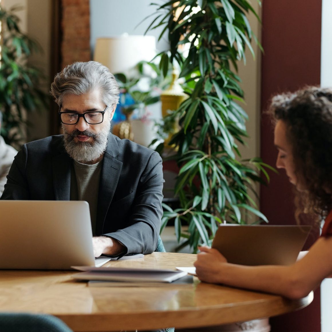 a man in gray suit using his laptop