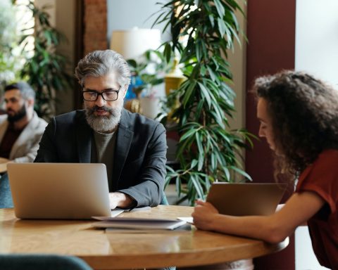 a man in gray suit using his laptop