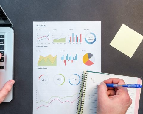 person writing on notebook