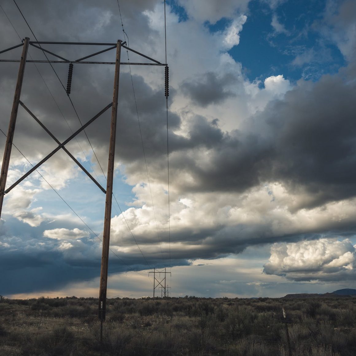 view of electric cable lines under cloudy day