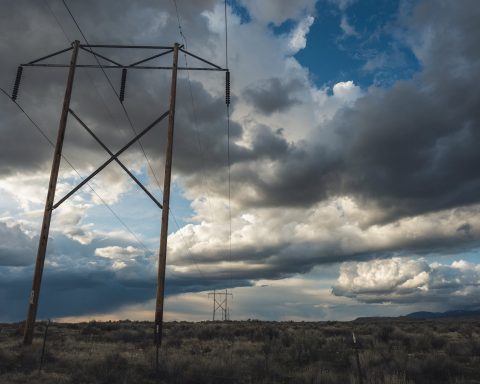 view of electric cable lines under cloudy day