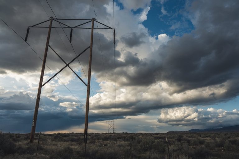 view of electric cable lines under cloudy day
