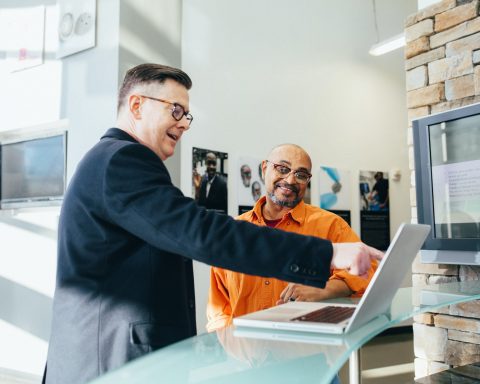 man pointing laptop computer