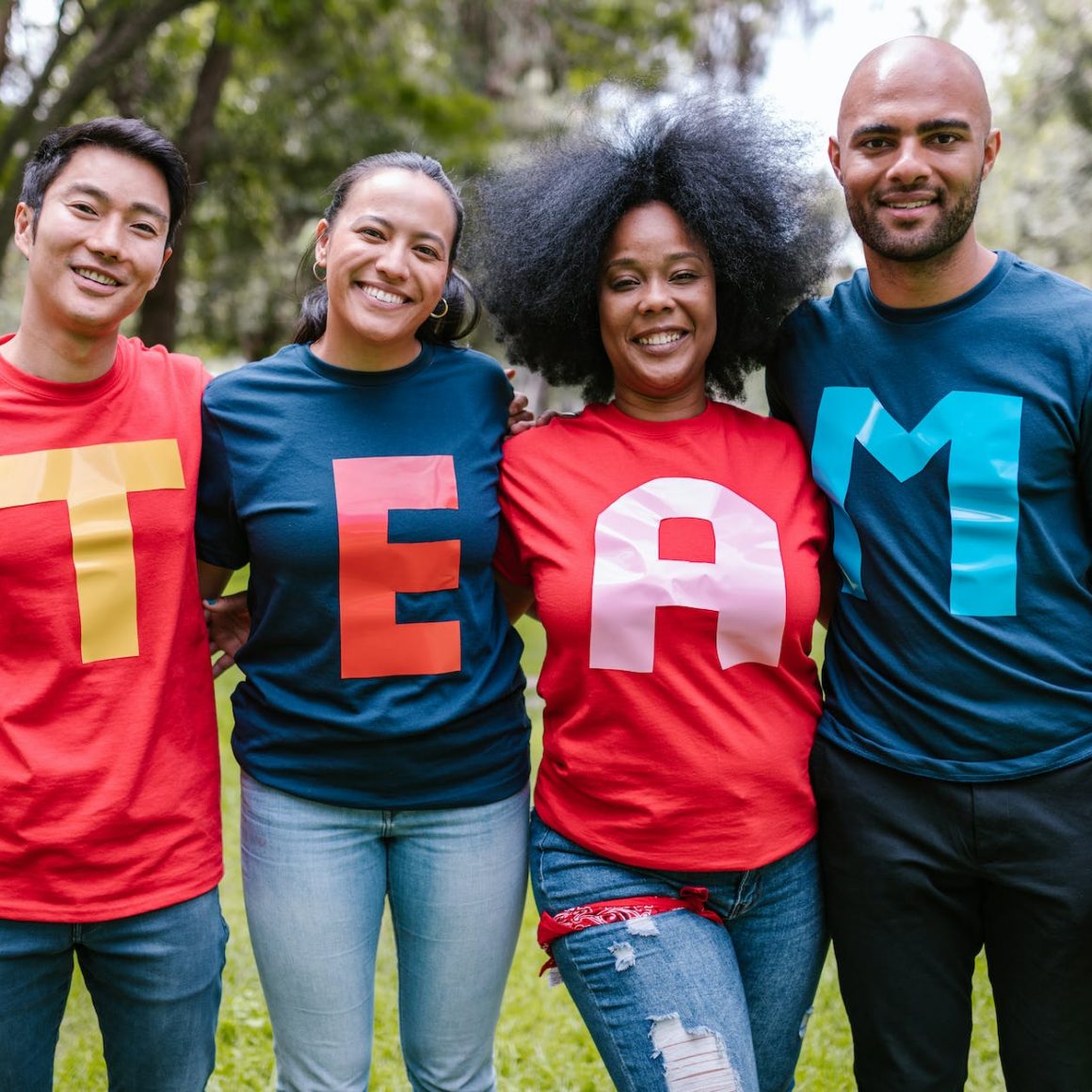 group of people wearing shirts spelled team