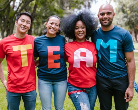 group of people wearing shirts spelled team