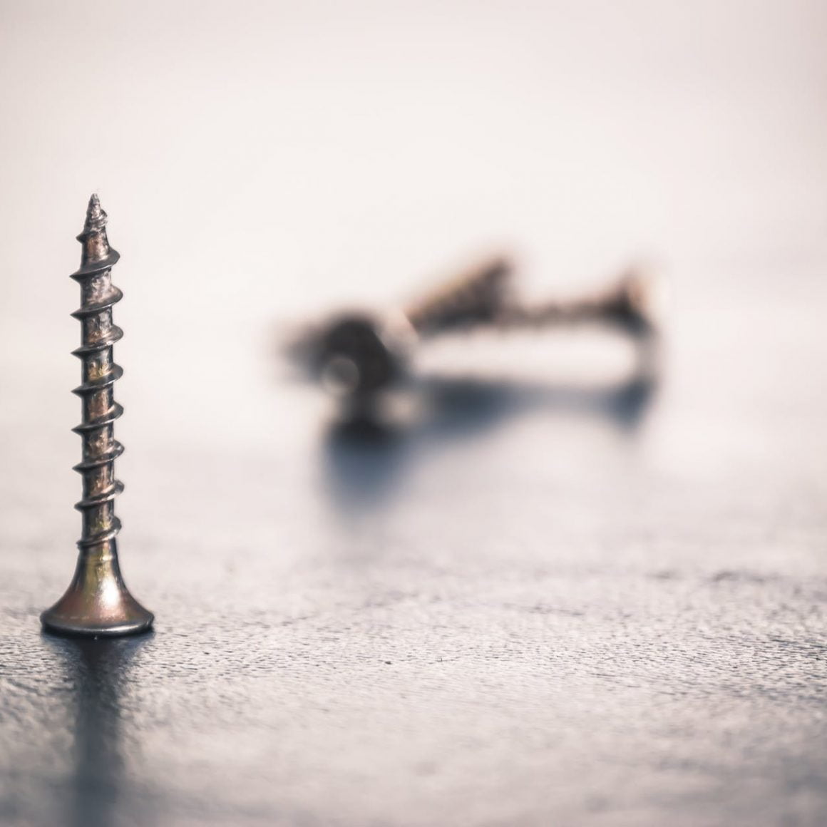 shallow focus photo of screw