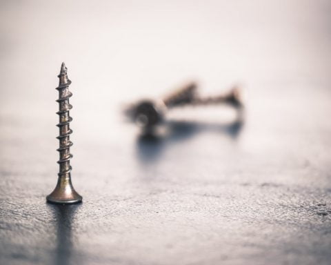 shallow focus photo of screw
