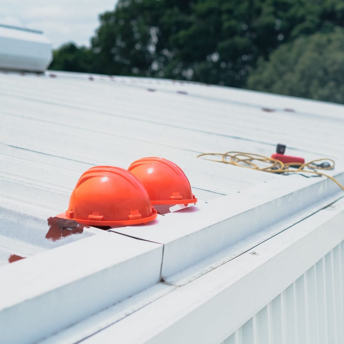 red helmet on white wooden fence