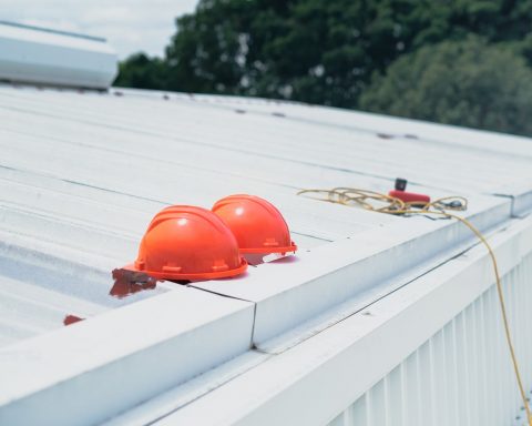 red helmet on white wooden fence