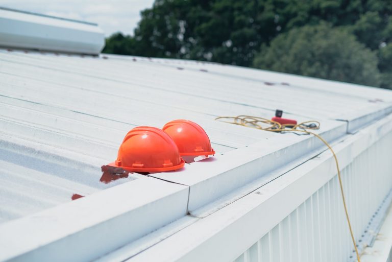 red helmet on white wooden fence